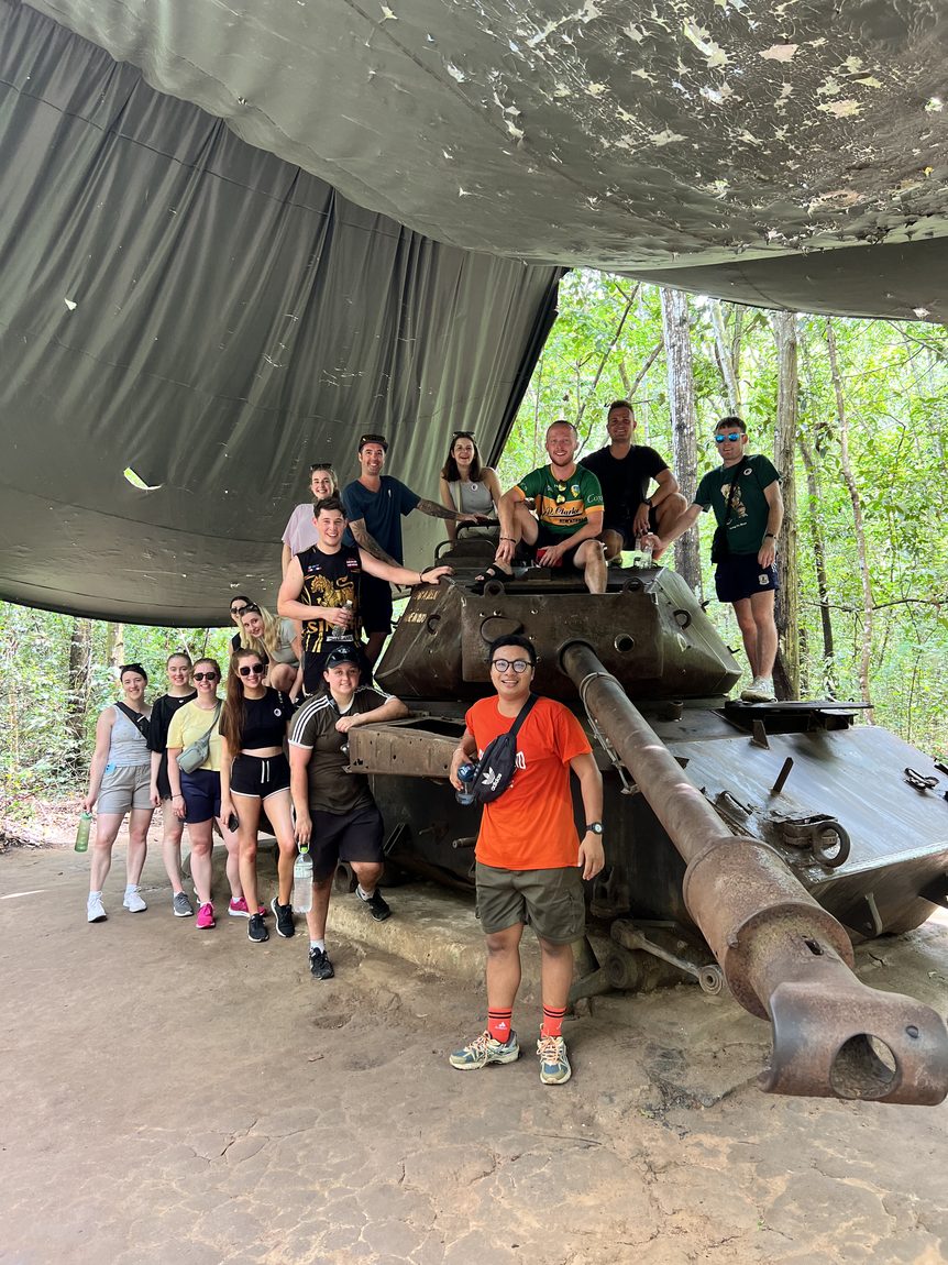 Group beside an old tank at the Cu Chi tunnels