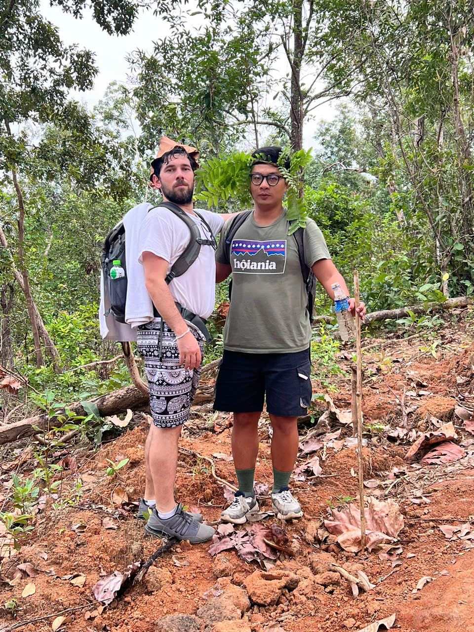 Travellers hiking to a jungle waterfall