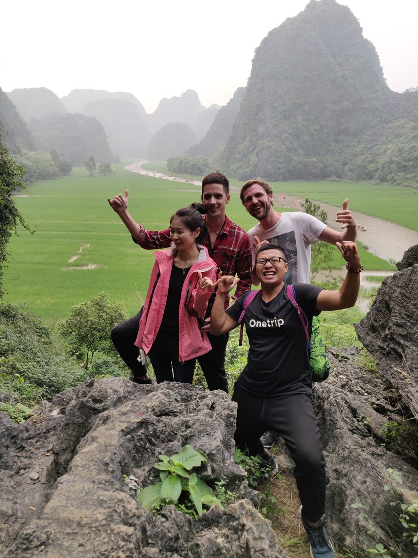 Travellers up on a rock above the rice fields
