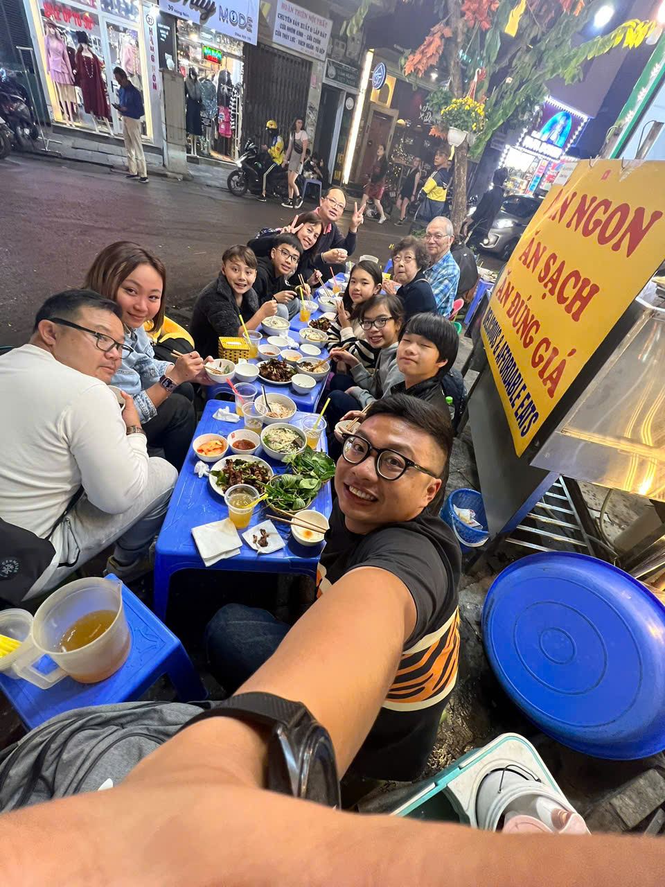 Sharing street food at a dinner table in Vietnam