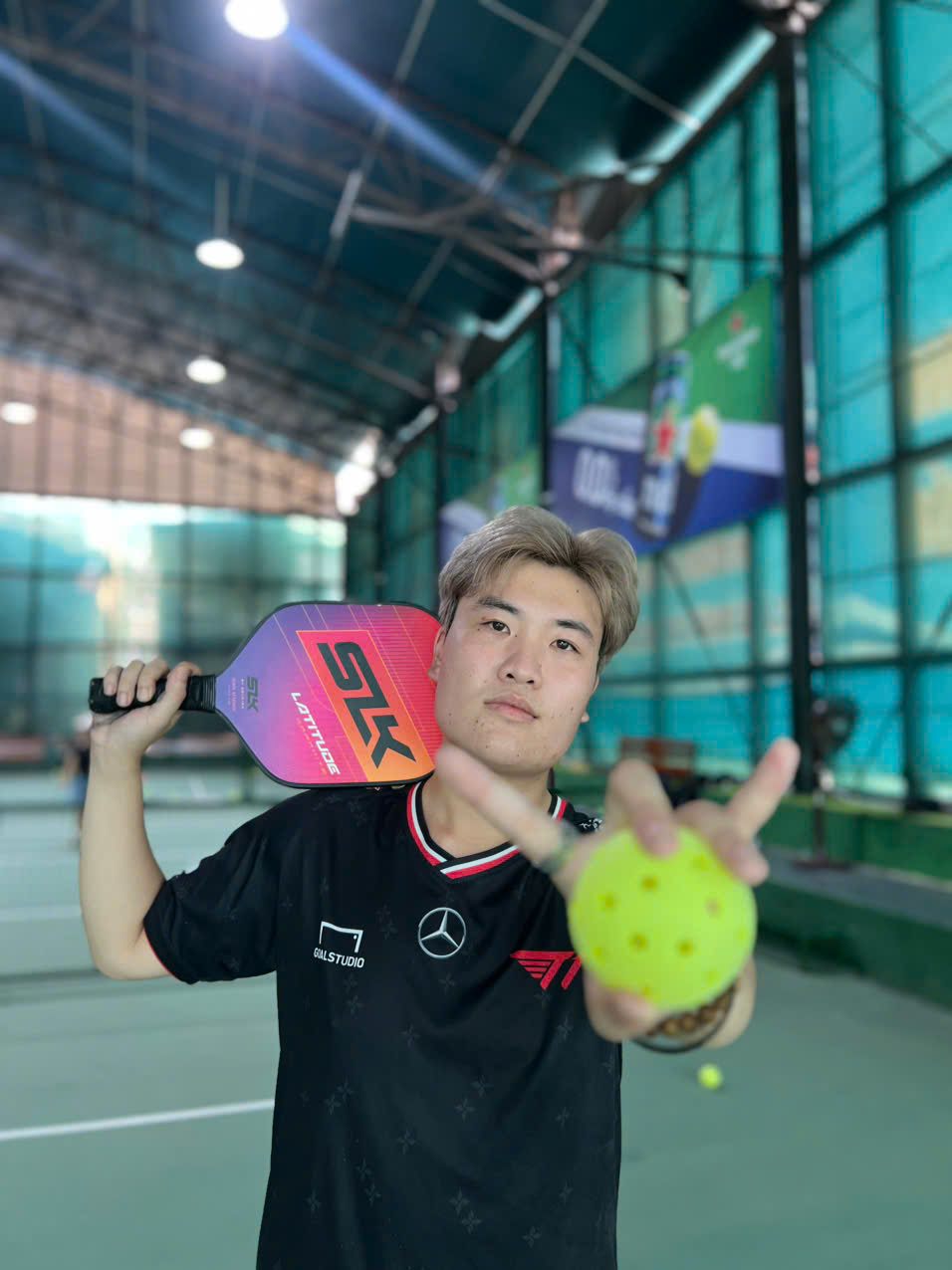 Tuan Tu, one of our tour guides, holding up a pickleball at Taurus, Hanoi