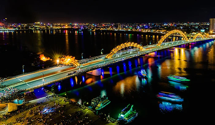Dragon Bridge lit up over the Han River at sunset, Da Nang