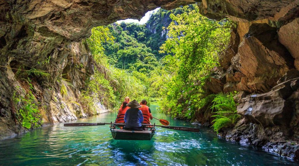 Boat on the river through Trang An's karst cliffs, Ninh Binh