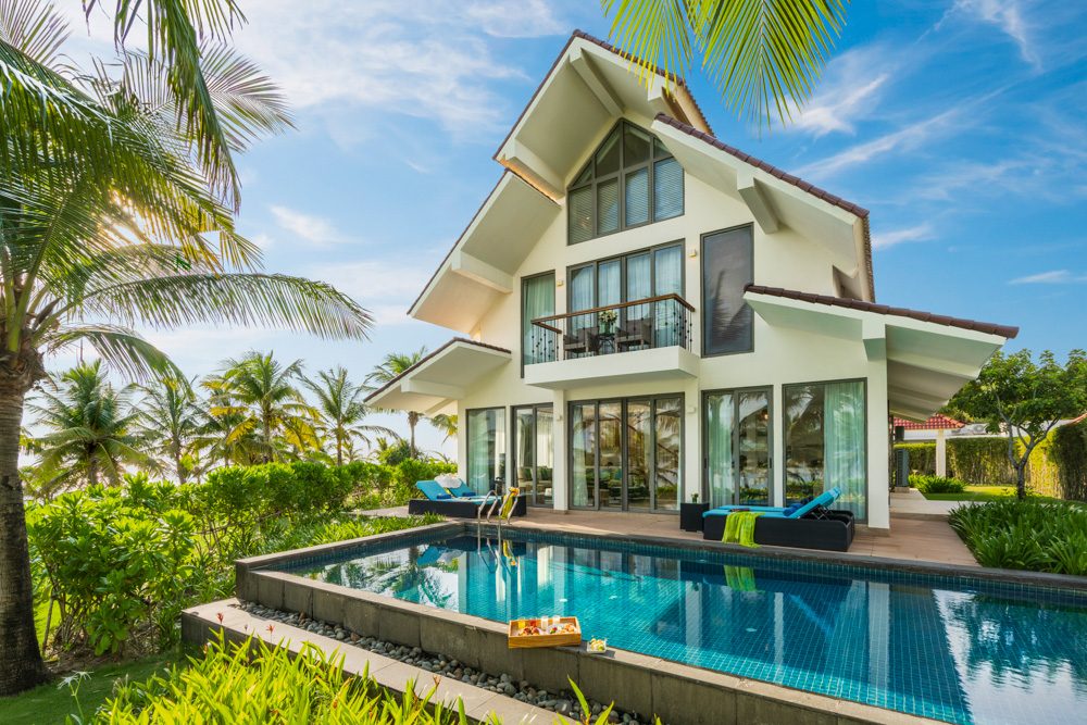 A private pool villa framed by palms in Hoi An