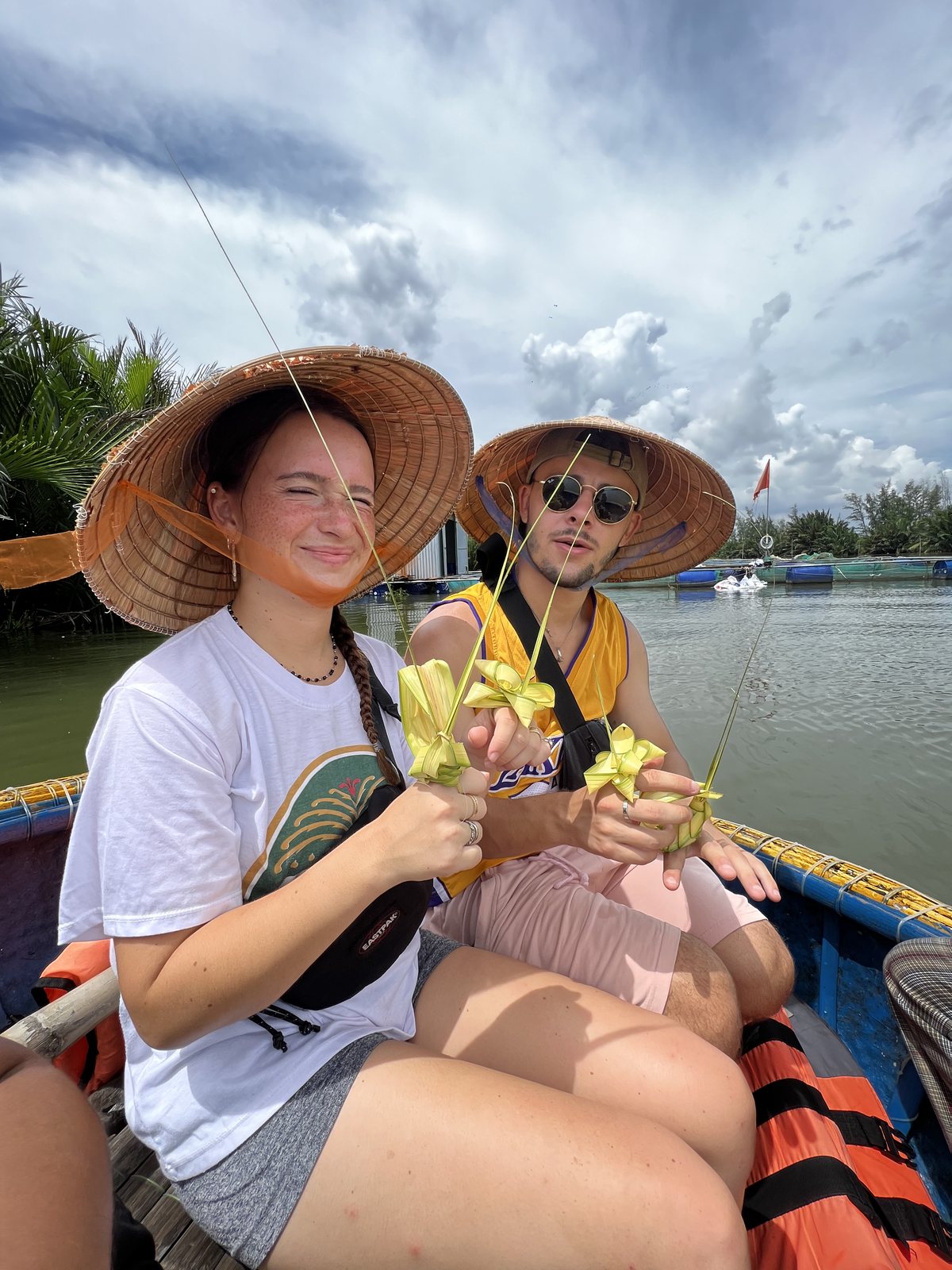 Guests in conical hats on a basket boat in the Cam Thanh coconut forest, Hoi An