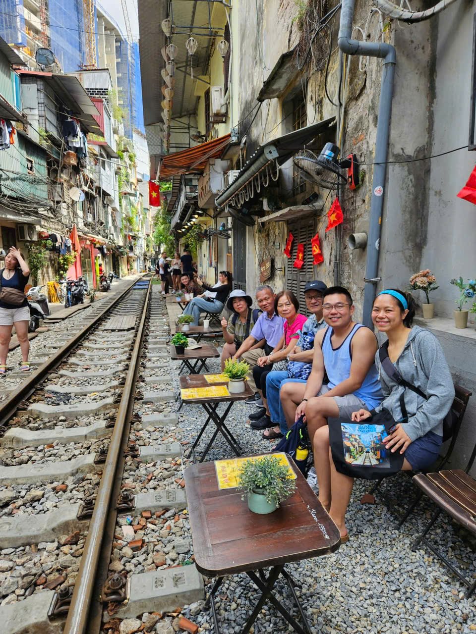 Our guests having coffee on Hanoi's Train Street, on one of our trips