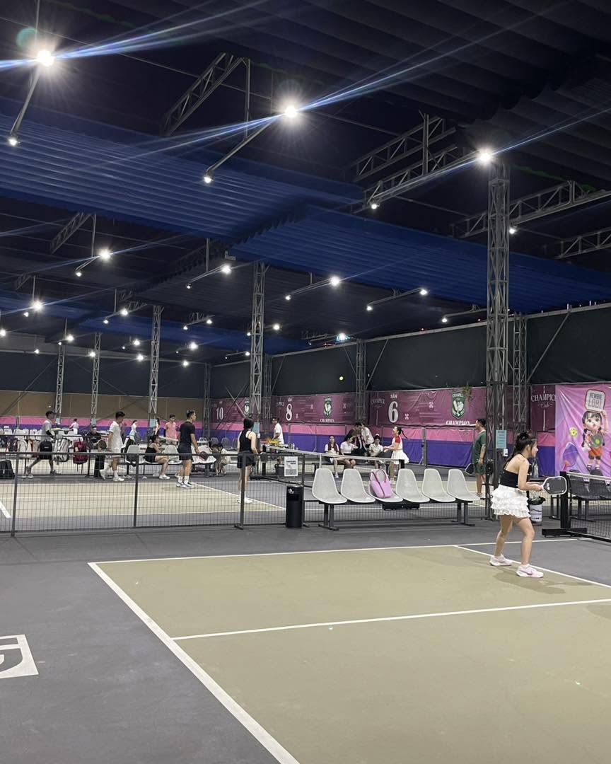 An indoor pickleball court in Hanoi with players between games