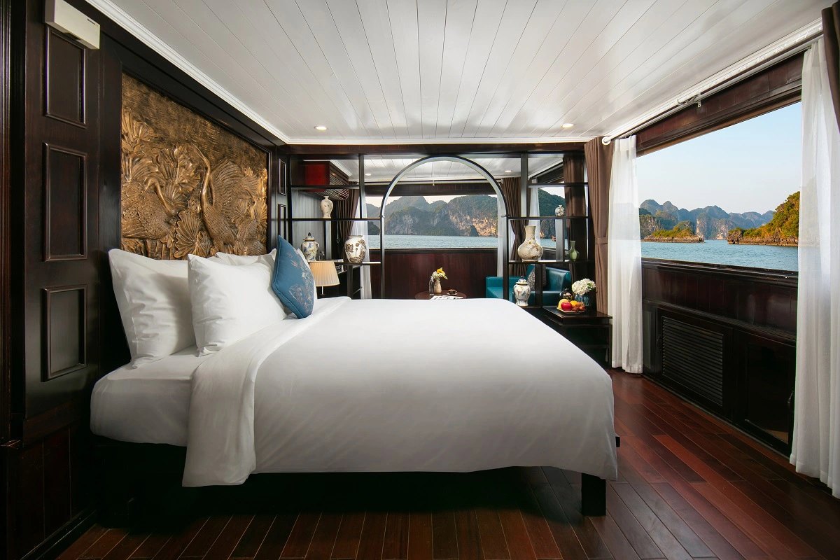 A cabin on an overnight cruise boat with a window looking out over Ha Long Bay
