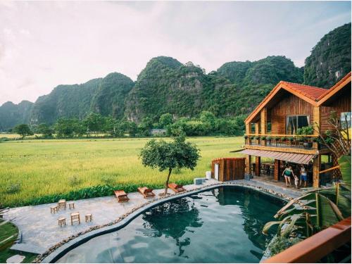 A homestay bungalow surrounded by rice fields and limestone karsts in Ninh Binh