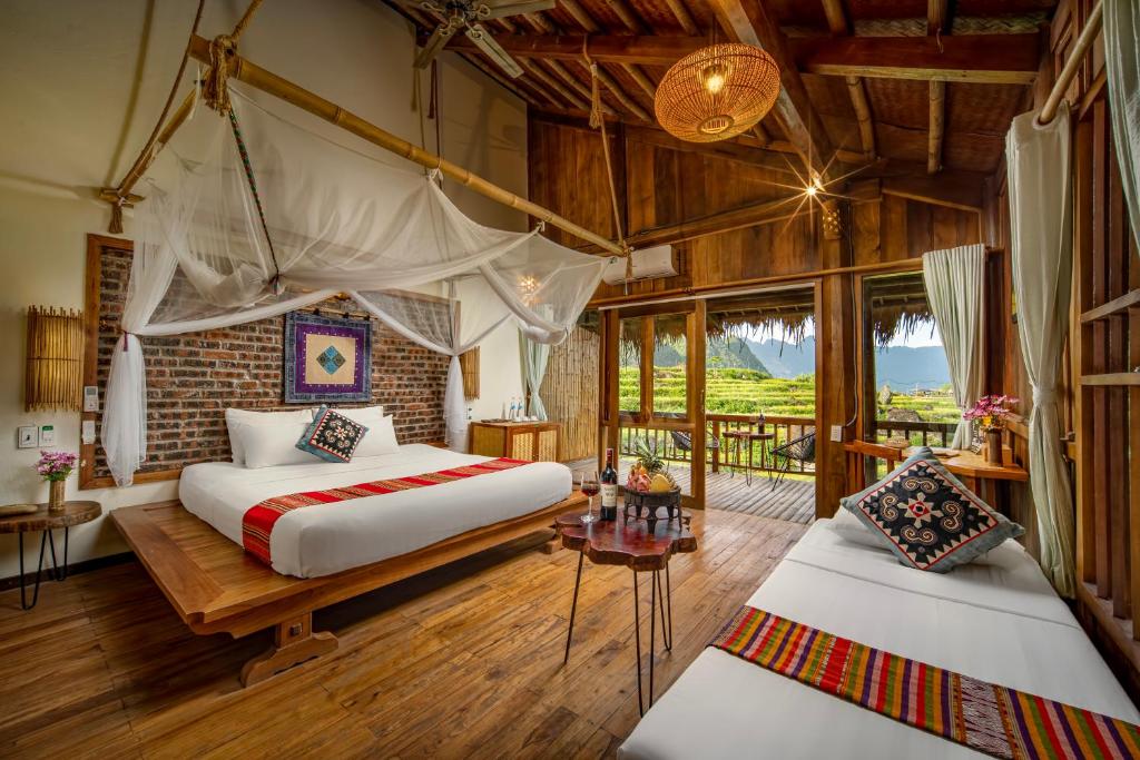 Bungalows overlooking terraced rice fields at an eco-resort in Pu Luong