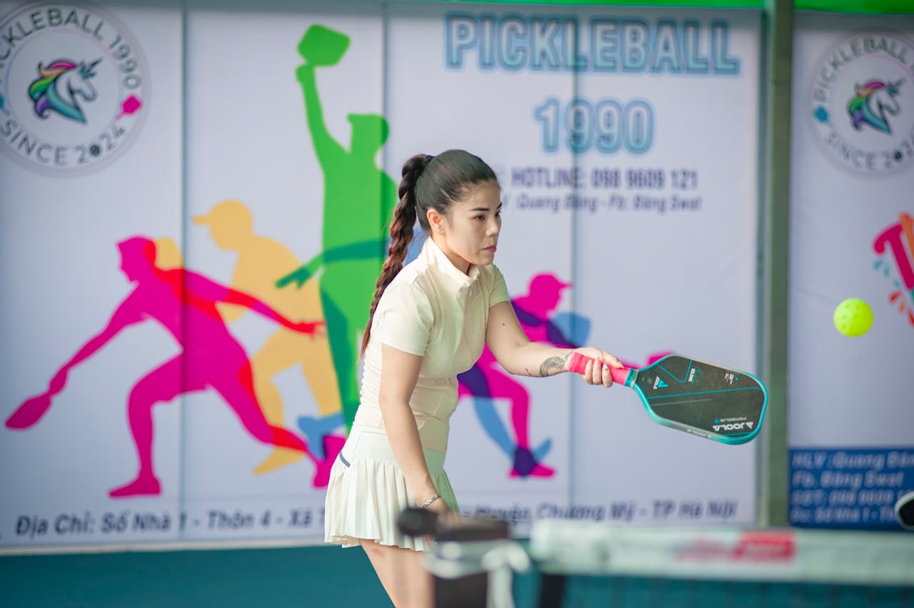 Crafting Captivating Headlines: Your awesome post title goes here Woman actively engaged in a game of pickleball indoors in Hanoi, Vietnam.